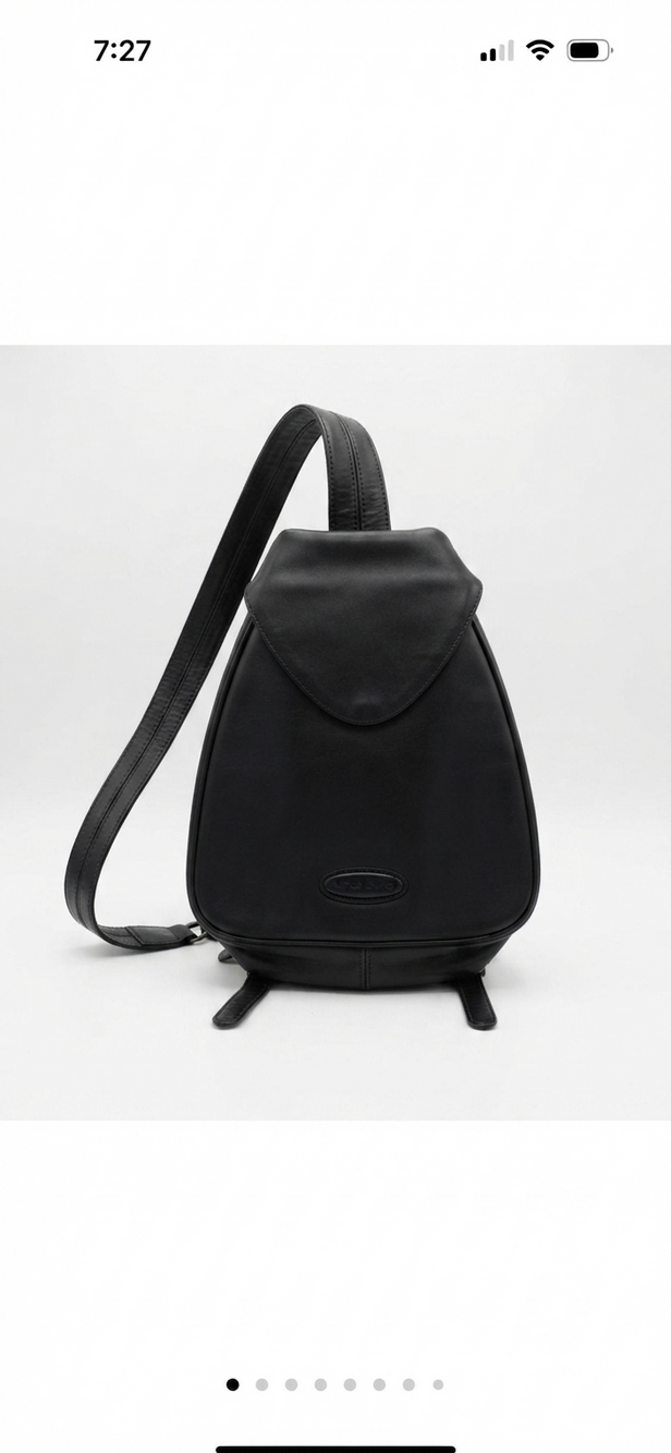 Alfred Sung black convertible sling backpack with flap top and zip pocket